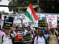 Citizens shout slogans during a protest against the rape and murder of a PGT woman doctor at the government-run R G Kar Medical College and...