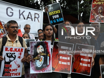 Citizens shout slogans during a protest against the rape and murder of a PGT woman doctor at the government-run R G Kar Medical College and...