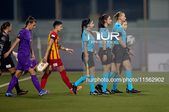 UEFA-appointed match referee Tatyana Sorokopudova leads her assistant referees, fourth official, and team captains onto the pitch prior to t...