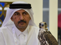 A Qatari exhibitor shows a falcon during the 8th edition of the Katara International Hunting and Falcons Exhibition 2024 (S'hail) at Katara...