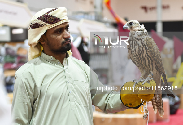 An exhibitor shows a falcon during the 8th edition of the Katara International Hunting and Falcons Exhibition 2024 (S'hail) at Katara Cultur...