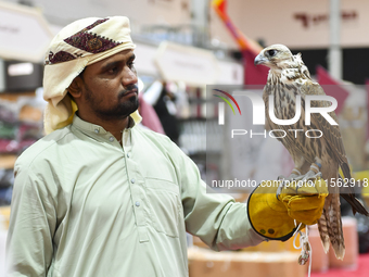 An exhibitor shows a falcon during the 8th edition of the Katara International Hunting and Falcons Exhibition 2024 (S'hail) at Katara Cultur...