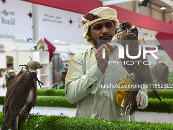 A Qatari exhibitor shows a falcon during the 8th edition of the Katara International Hunting and Falcons Exhibition 2024 (S'hail) at Katara...