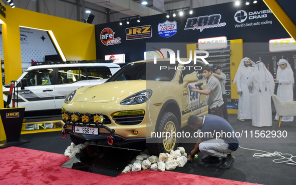 Visitors look at hunting vehicles during the 8th edition of the Katara International Hunting and Falcons Exhibition 2024 (S'hail) at Katara...