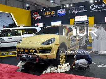 Visitors look at hunting vehicles during the 8th edition of the Katara International Hunting and Falcons Exhibition 2024 (S'hail) at Katara...