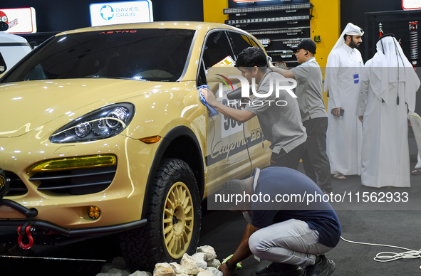 Visitors look at hunting vehicles during the 8th edition of the Katara International Hunting and Falcons Exhibition 2024 (S'hail) at Katara...