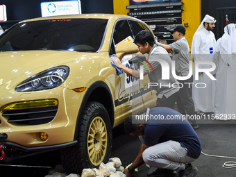 Visitors look at hunting vehicles during the 8th edition of the Katara International Hunting and Falcons Exhibition 2024 (S'hail) at Katara...