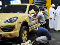 Visitors look at hunting vehicles during the 8th edition of the Katara International Hunting and Falcons Exhibition 2024 (S'hail) at Katara...