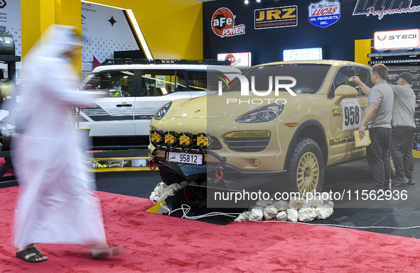 Visitors look at hunting vehicles during the 8th edition of the Katara International Hunting and Falcons Exhibition 2024 (S'hail) at Katara...