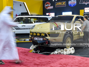 Visitors look at hunting vehicles during the 8th edition of the Katara International Hunting and Falcons Exhibition 2024 (S'hail) at Katara...