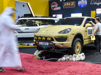 Visitors look at hunting vehicles during the 8th edition of the Katara International Hunting and Falcons Exhibition 2024 (S'hail) at Katara...