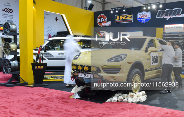 Visitors look at hunting vehicles during the 8th edition of the Katara International Hunting and Falcons Exhibition 2024 (S'hail) at Katara...