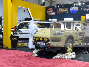 Visitors look at hunting vehicles during the 8th edition of the Katara International Hunting and Falcons Exhibition 2024 (S'hail) at Katara...