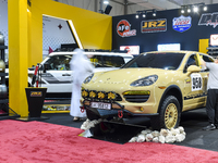 Visitors look at hunting vehicles during the 8th edition of the Katara International Hunting and Falcons Exhibition 2024 (S'hail) at Katara...