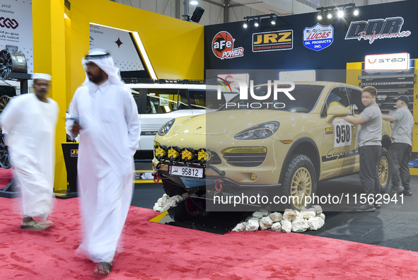 Visitors look at hunting vehicles during the 8th edition of the Katara International Hunting and Falcons Exhibition 2024 (S'hail) at Katara...