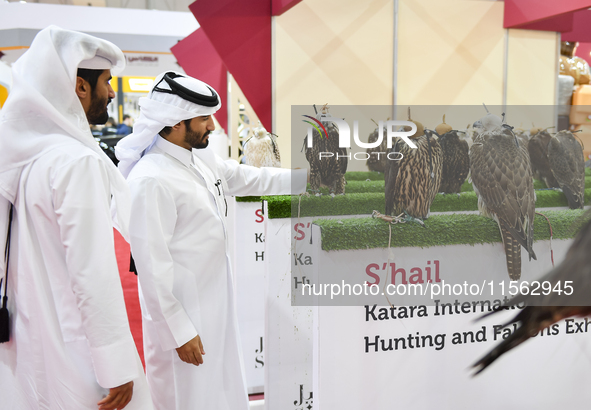 Qatari visitors observe falcons during the 8th edition of the Katara International Hunting and Falcons Exhibition 2024 (S'hail) at Katara Cu...