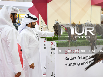 Qatari visitors observe falcons during the 8th edition of the Katara International Hunting and Falcons Exhibition 2024 (S'hail) at Katara Cu...