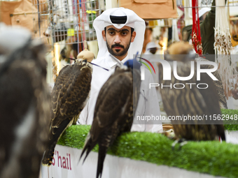 Qatari visitors observe falcons during the 8th edition of the Katara International Hunting and Falcons Exhibition 2024 (S'hail) at Katara Cu...