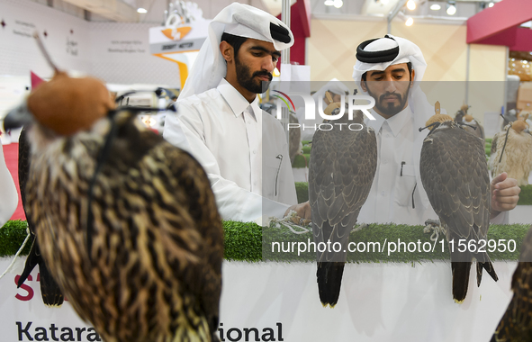 Qatari visitors observe falcons during the 8th edition of the Katara International Hunting and Falcons Exhibition 2024 (S'hail) at Katara Cu...