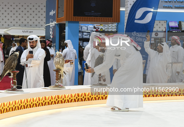 Qatari visitors observe falcons during the 8th edition of the Katara International Hunting and Falcons Exhibition 2024 (S'hail) at Katara Cu...