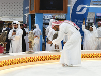 Qatari visitors observe falcons during the 8th edition of the Katara International Hunting and Falcons Exhibition 2024 (S'hail) at Katara Cu...