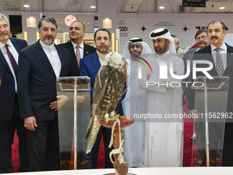 Qatari visitors observe falcons during the 8th edition of the Katara International Hunting and Falcons Exhibition 2024 (S'hail) at Katara Cu...