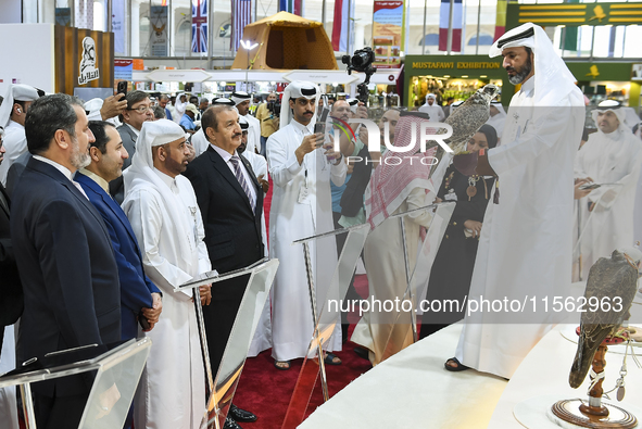 Qatari visitors observe falcons during the 8th edition of the Katara International Hunting and Falcons Exhibition 2024 (S'hail) at Katara Cu...