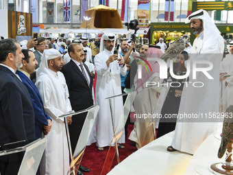 Qatari visitors observe falcons during the 8th edition of the Katara International Hunting and Falcons Exhibition 2024 (S'hail) at Katara Cu...