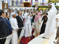 Qatari visitors observe falcons during the 8th edition of the Katara International Hunting and Falcons Exhibition 2024 (S'hail) at Katara Cu...