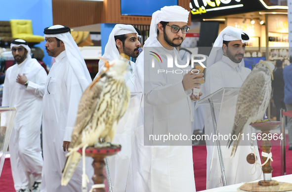 Qatari visitors observe falcons during the 8th edition of the Katara International Hunting and Falcons Exhibition 2024 (S'hail) at Katara Cu...