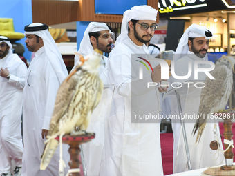 Qatari visitors observe falcons during the 8th edition of the Katara International Hunting and Falcons Exhibition 2024 (S'hail) at Katara Cu...