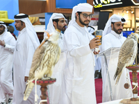 Qatari visitors observe falcons during the 8th edition of the Katara International Hunting and Falcons Exhibition 2024 (S'hail) at Katara Cu...