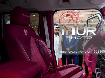 Visitors look at hunting vehicles during the 8th edition of the Katara International Hunting and Falcons Exhibition 2024 (S'hail) at Katara...