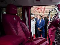 Visitors look at hunting vehicles during the 8th edition of the Katara International Hunting and Falcons Exhibition 2024 (S'hail) at Katara...