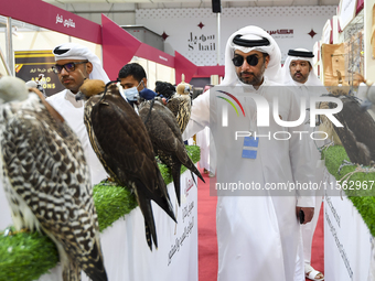 Qatari visitors observe falcons during the 8th edition of the Katara International Hunting and Falcons Exhibition 2024 (S'hail) at Katara Cu...