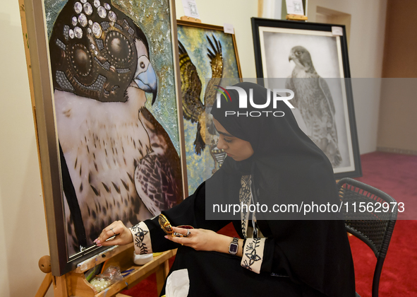 An artist paints a falcon during the 8th edition of the Katara International Hunting and Falcons Exhibition 2024 (S'hail) at Katara Cultural...