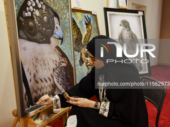 An artist paints a falcon during the 8th edition of the Katara International Hunting and Falcons Exhibition 2024 (S'hail) at Katara Cultural...