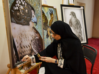 An artist paints a falcon during the 8th edition of the Katara International Hunting and Falcons Exhibition 2024 (S'hail) at Katara Cultural...