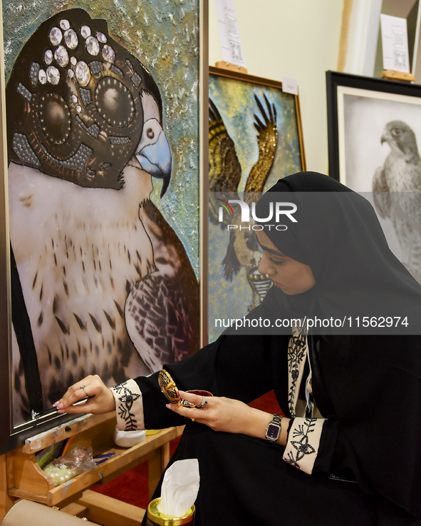 An artist paints a falcon during the 8th edition of the Katara International Hunting and Falcons Exhibition 2024 (S'hail) at Katara Cultural...