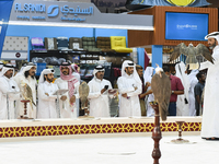 Visitors look at perched falcons while hooded during the 8th edition of the Katara International Hunting and Falcons Exhibition 2024 (S'hail...