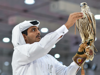 An exhibitor shows a falcon during the 8th edition of the Katara International Hunting and Falcons Exhibition 2024 (S'hail) at Katara Cultur...