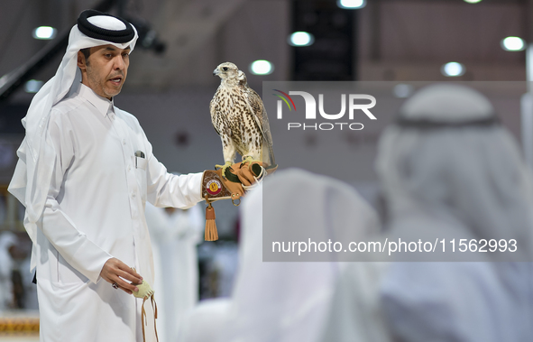 An exhibitor shows a falcon during the 8th edition of the Katara International Hunting and Falcons Exhibition 2024 (S'hail) at Katara Cultur...