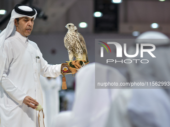 An exhibitor shows a falcon during the 8th edition of the Katara International Hunting and Falcons Exhibition 2024 (S'hail) at Katara Cultur...