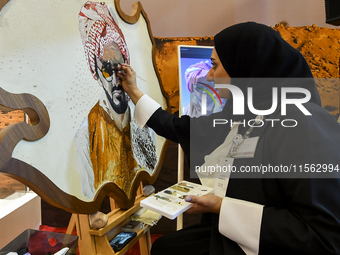 An artist paints a falcon during the 8th edition of the Katara International Hunting and Falcons Exhibition 2024 (S'hail) at Katara Cultural...