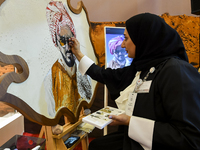 An artist paints a falcon during the 8th edition of the Katara International Hunting and Falcons Exhibition 2024 (S'hail) at Katara Cultural...