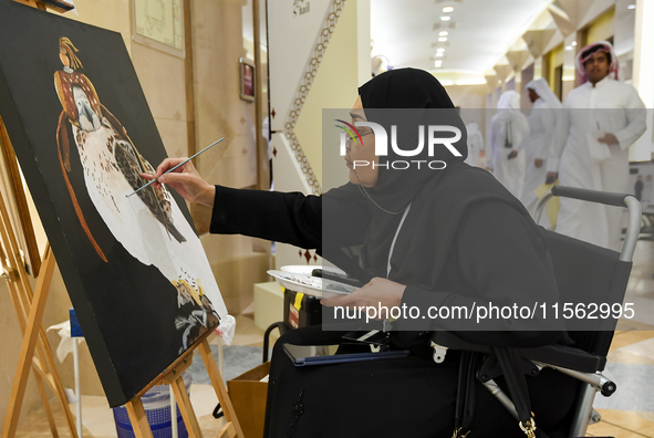 An artist paints a falcon during the 8th edition of the Katara International Hunting and Falcons Exhibition 2024 (S'hail) at Katara Cultural...