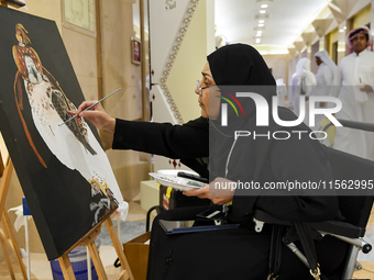 An artist paints a falcon during the 8th edition of the Katara International Hunting and Falcons Exhibition 2024 (S'hail) at Katara Cultural...