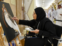 An artist paints a falcon during the 8th edition of the Katara International Hunting and Falcons Exhibition 2024 (S'hail) at Katara Cultural...