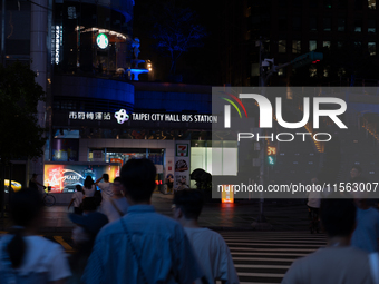 Pedestrians cross the street in Taipei, Taiwan, on September 10, 2024. (