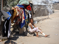 A Palestinian youth inspects the damage at the site of Israeli strikes on a makeshift displacement camp in Mawasi Khan Yunis in the Gaza Str...